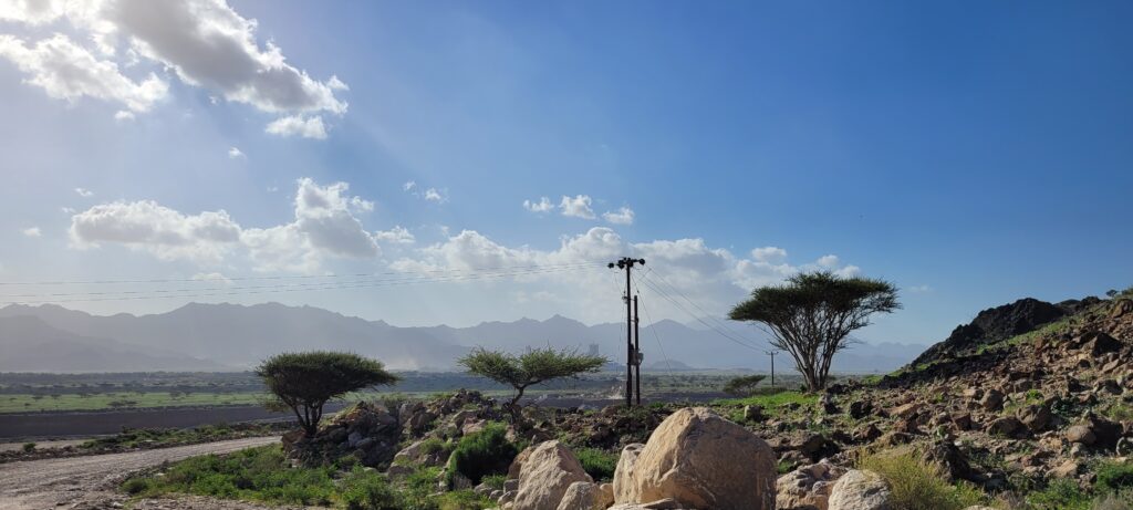 "Participants at the Fujairah Mountain Shooting 2025 event in UAE, preparing to shoot at one of the 24 stands set against the stunning mountain backdrop. The event combines competitive shooting with cultural experiences, offering unique challenges and substantial cash prizes."